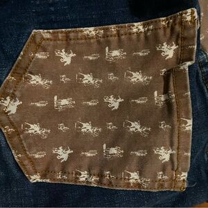 Super cute Ranch Dressn’ jeans with buckin’ broncos print on the pockets